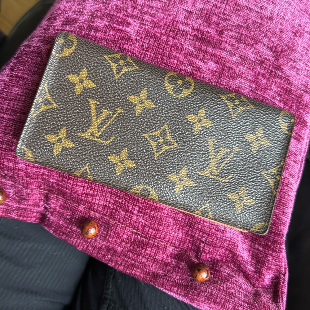 Louis Vuitton check book cover or perfect for cash bills.
